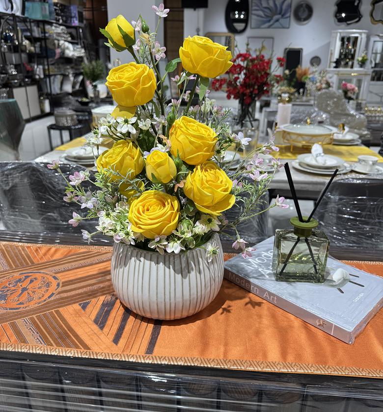 Elegant yellow roses in a white ribbed vase image