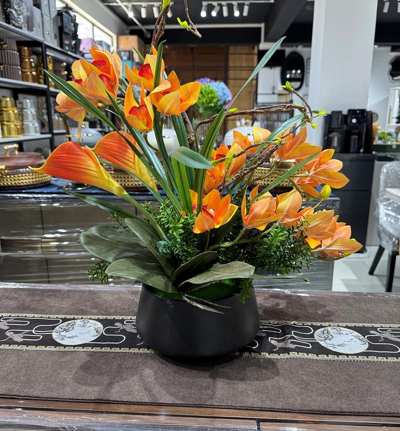 Orange Orchid in a black vase image