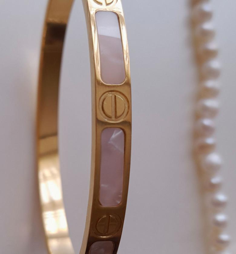 Gold love bracelet with a marble touch image