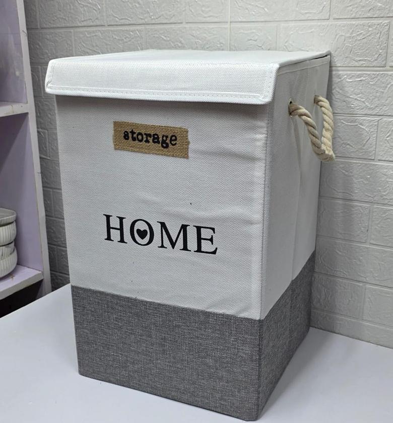 Large laundry basket with rope handles and top cover. image