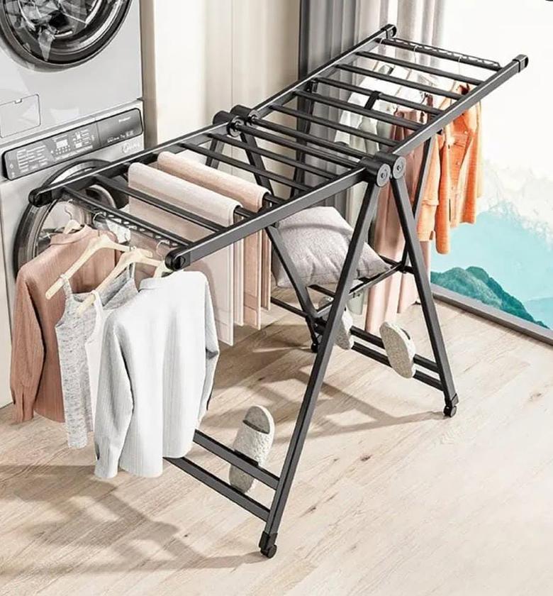 Foldable metallic clothes drying rack, with wheels for easy movement. image
