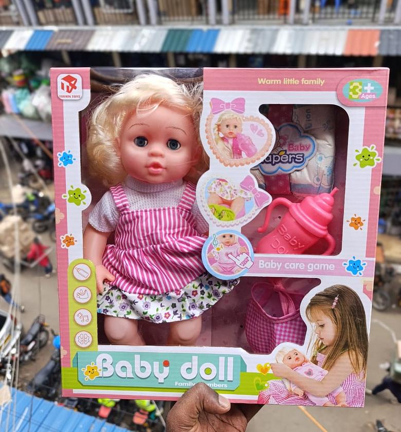 Doll. White baby doll with a care kit(feeding bottle and diapers) image