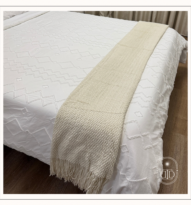 Beige throw blanket with tassels. image