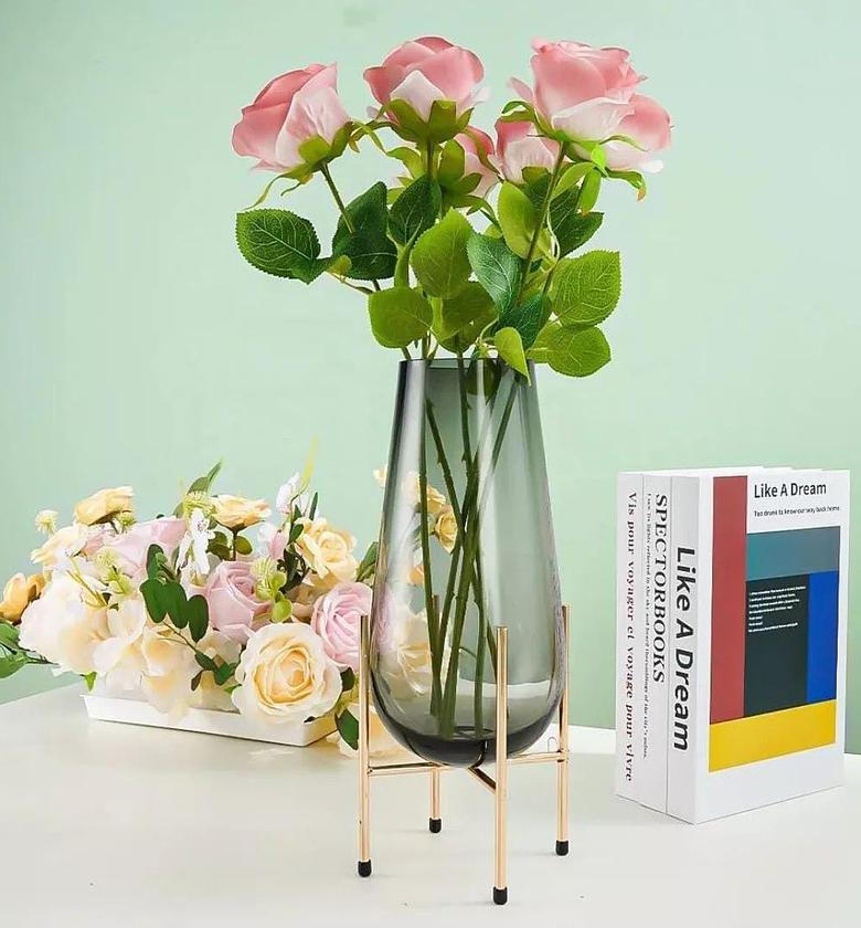 Modern creative dark glass vase with a gold stand. image