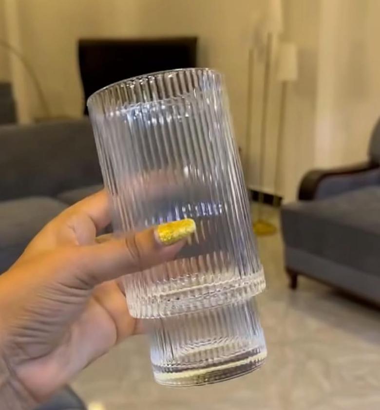 Long Rippled Glass with gold rim. image