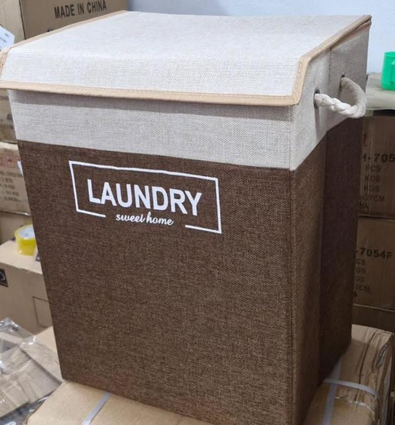 Large laundry basket with rope handles and top cover. image