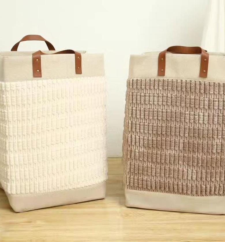 Large laundry basket with leather handles. image