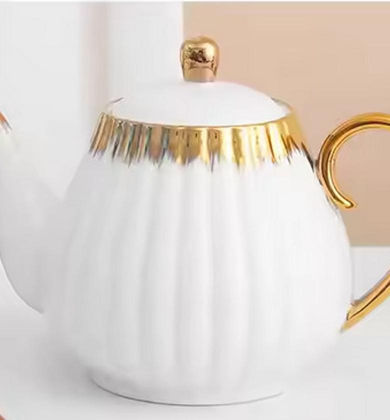 Gold detail kettle porcelain.  ✅ material: ceramic  ✅weight: 520g ✅ Capacity:1200ml ✅colour:white  image