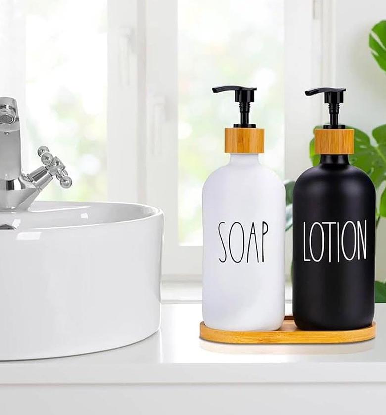 Ceramic 'soap/lotion' soap dispenser with wooden tray. image