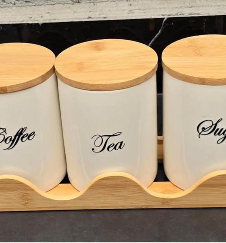 3pcs ceramic canisters with wooden base. image