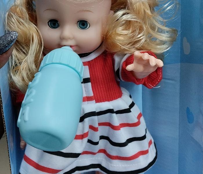 Talking and  blinking doll with a feeding bottle image