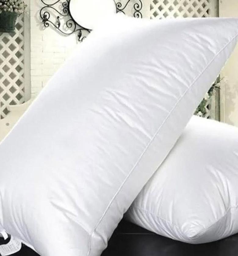 Vacuum sealed white bed pillows. image