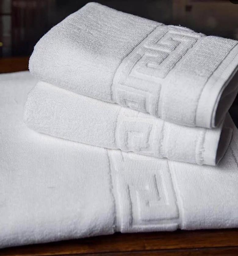 Medium size cotton white bath towels. image