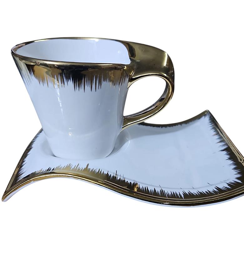 Cup and saucer gold and white image