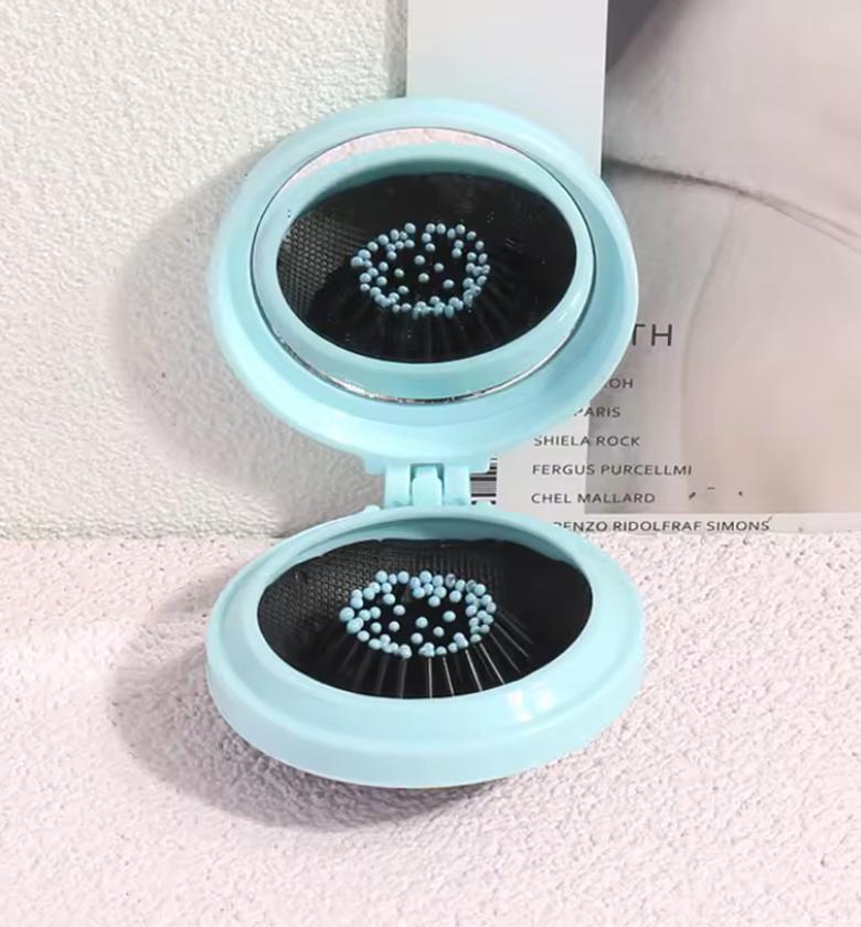 Mini pocket mirror with folding comb  image