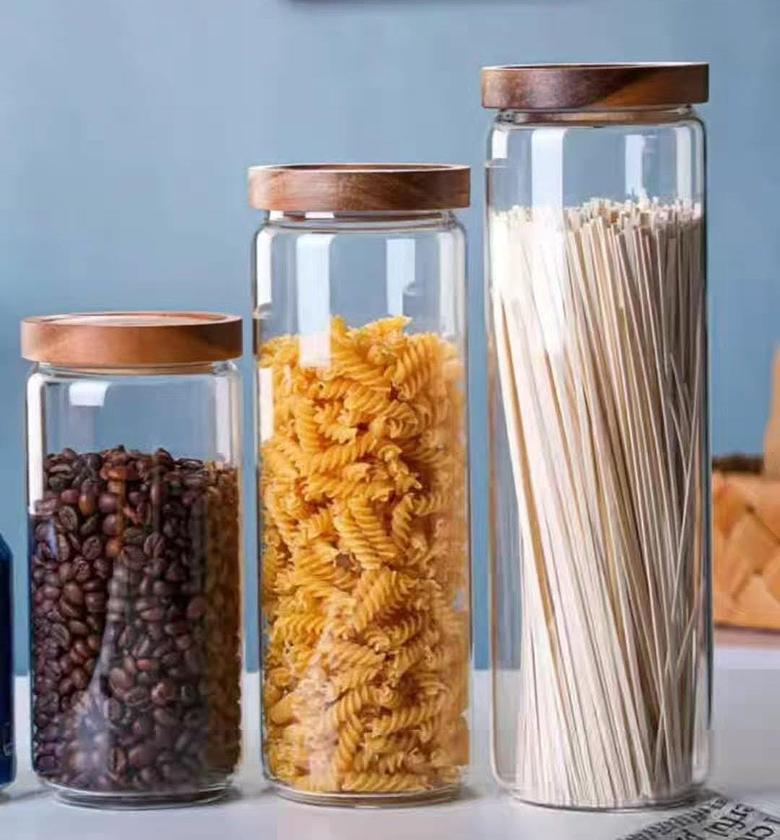 Glass storage jar with wooden lid. image