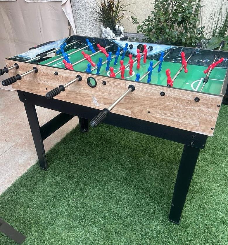  Foosball Table Game. Players use rods with attached figures to strike the ball into the opposing goal. image